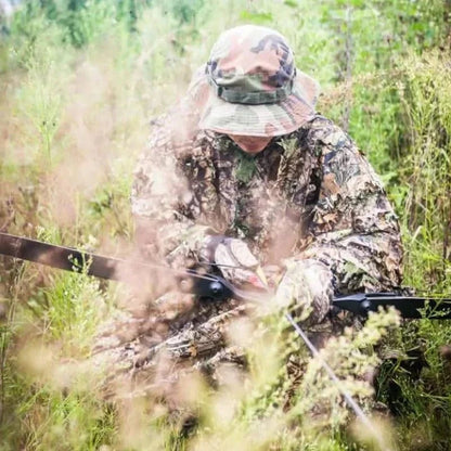 Camouflage Ghillie Suit for hunting in green terrain.